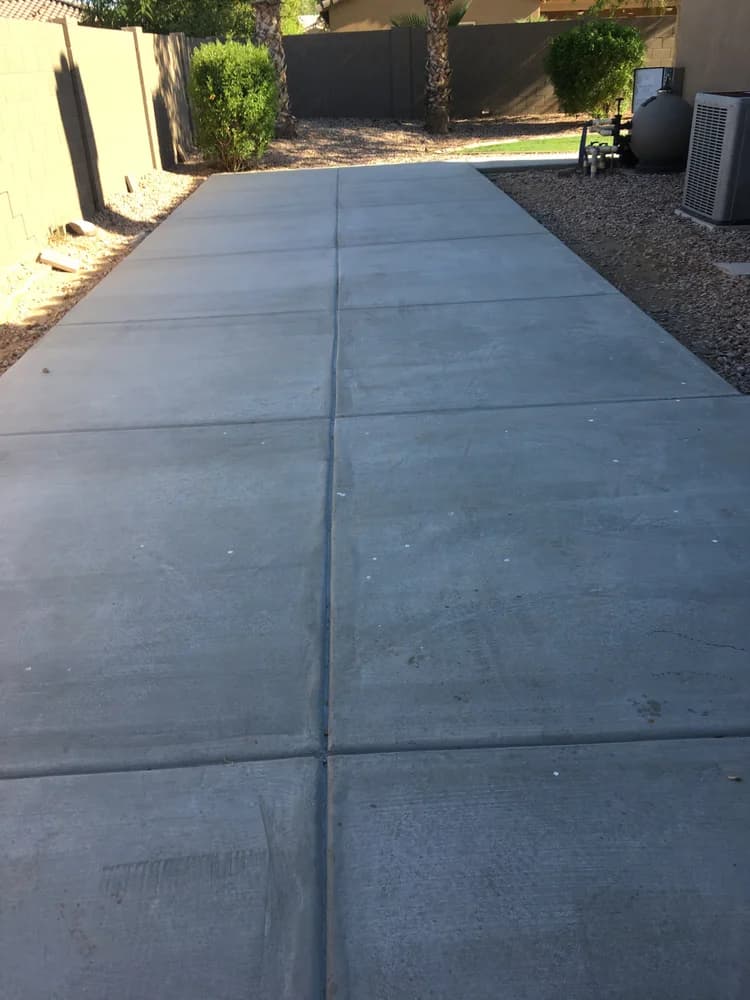 Newly poured concrete flatwork walkway alongside desert landscaping